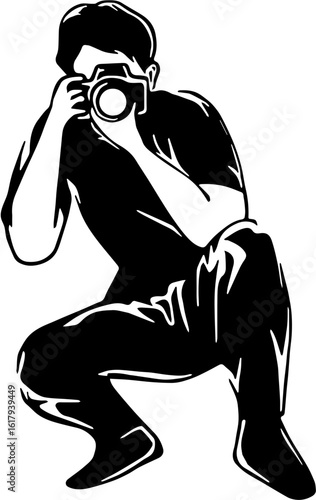Silhouette of a photographer crouched, taking a picture.