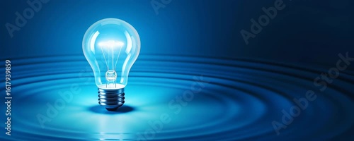 Light bulb floating on water with ripple and blue reflection, glowing bright symbolizing innovation and idea in calm water surface environment