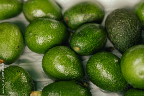 Fresh avocado at small local urban market. Organic produce on sale at outdoor farmer market. Selling fresh crops and veggies harvest. European urban setting. Close up. Part of the series