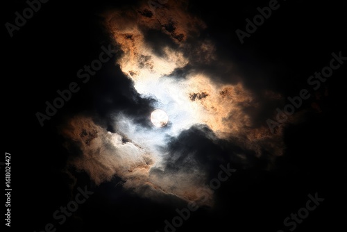 Sun obscured by dramatic clouds at night