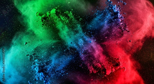 Colorful powder explosion of red green and blue colors on a black background.