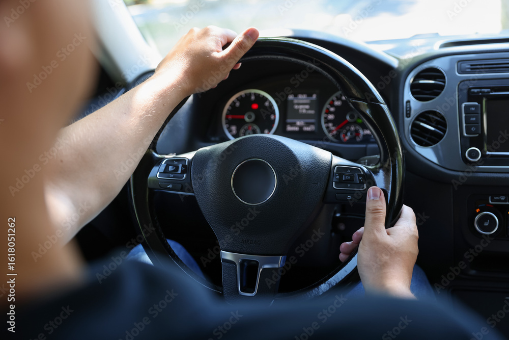 Man driving car with steering wheel, closeup Man driving car with steering wheel, closeup
