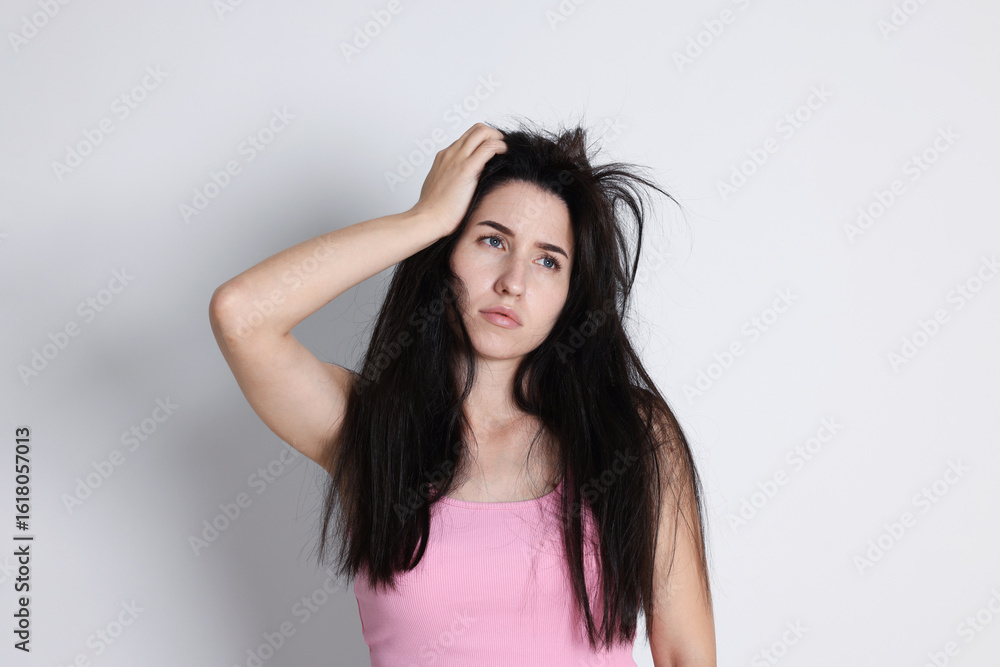 Naklejka premium Woman suffering from hangover on light grey background