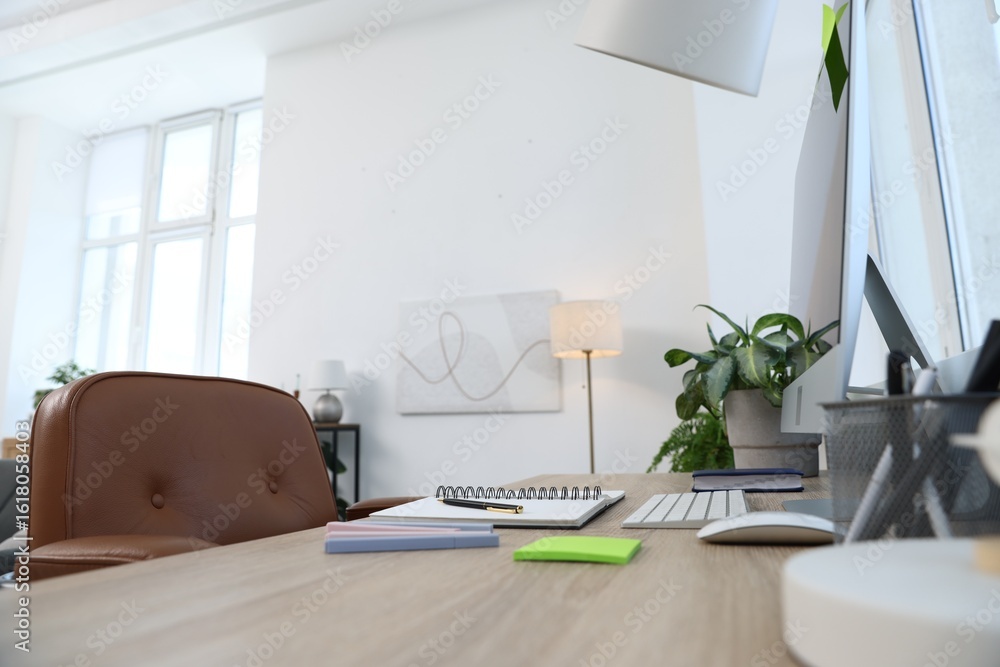 Fototapeta premium Modern computer and stationery on wooden desk in office, closeup. Comfortable workplace
