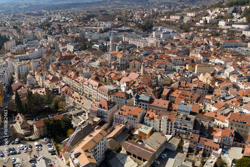 Wallpaper Mural Aerial view of traditional residential rooftops in a southeastern French town with dense urban architecture and surrounding hills under clear sky Torontodigital.ca