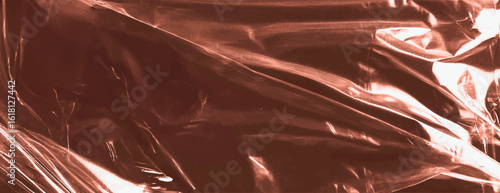 Glossy copper background with a metallic sheen. The background features smooth, reflective copper textures, creating a shiny effect. Plastic foil wrap texture background. Brown background vector.