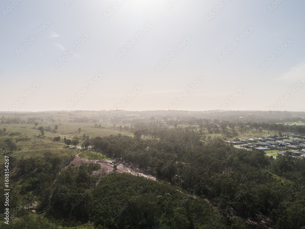 Dust storm haze on horizon over Australian landscape at edge of town Dust storm haze on horizon over Australian landscape at edge of town