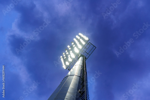 a modern lighting mast with LED spotlights at a sports stadium