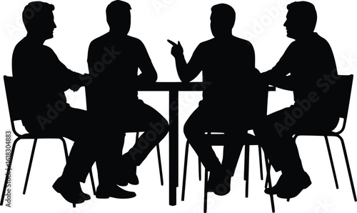 Silhouette of four people seated around table engaged in meeting and discussion