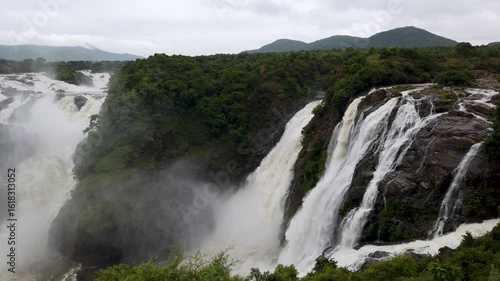Mysuru, Karnataka, India-June 12 2025; A Colossal Waterfall, cascade, rapid, cataract, gagana chukki, bluff, rock, rainforest, cloud of mist, fog, water, jog fall, flowing in western Ghats of India,