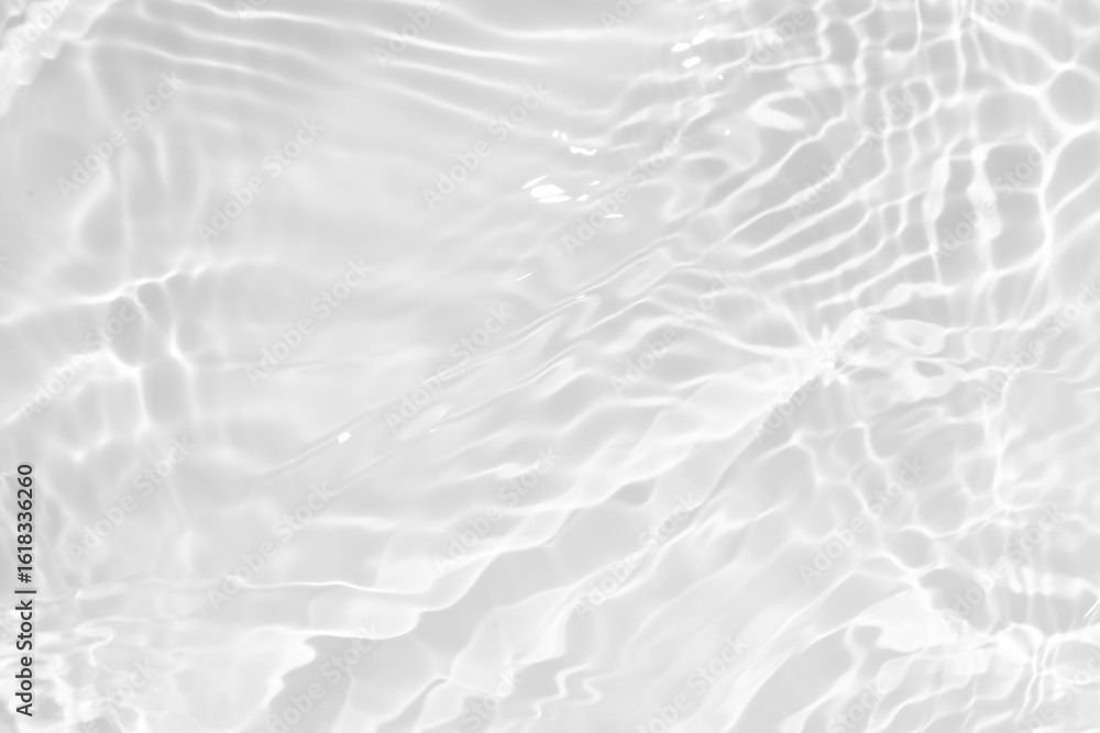 Fototapeta premium White water with ripples on the surface. Defocus blurred transparent white colored clear calm water surface texture with splashes and bubbles. Water waves with shining pattern texture background.