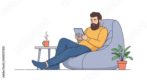A relaxed man enjoys his tablet while sitting in a comfortable beanbag chair with a hot drink nearby