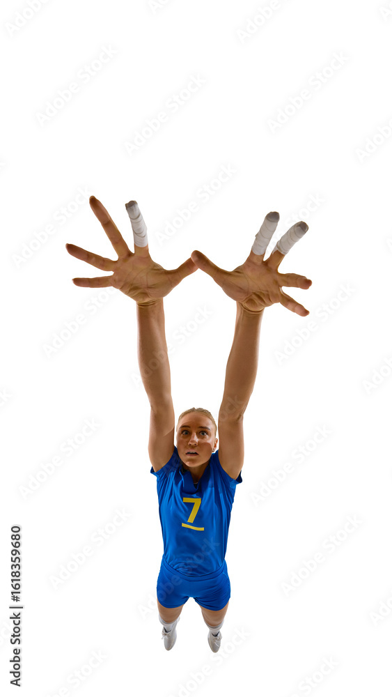 Fototapeta premium Full-body female volleyball player jumping high with arms raised to block, focused and determined. Concept of summer games, defensive skills, coaching materials, and sports education.