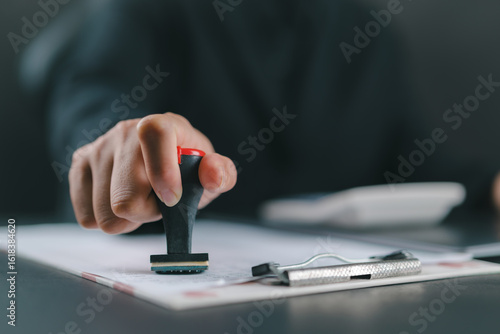 Sign Approved Stamp On Document to permit and certify for work document and visa At Desk