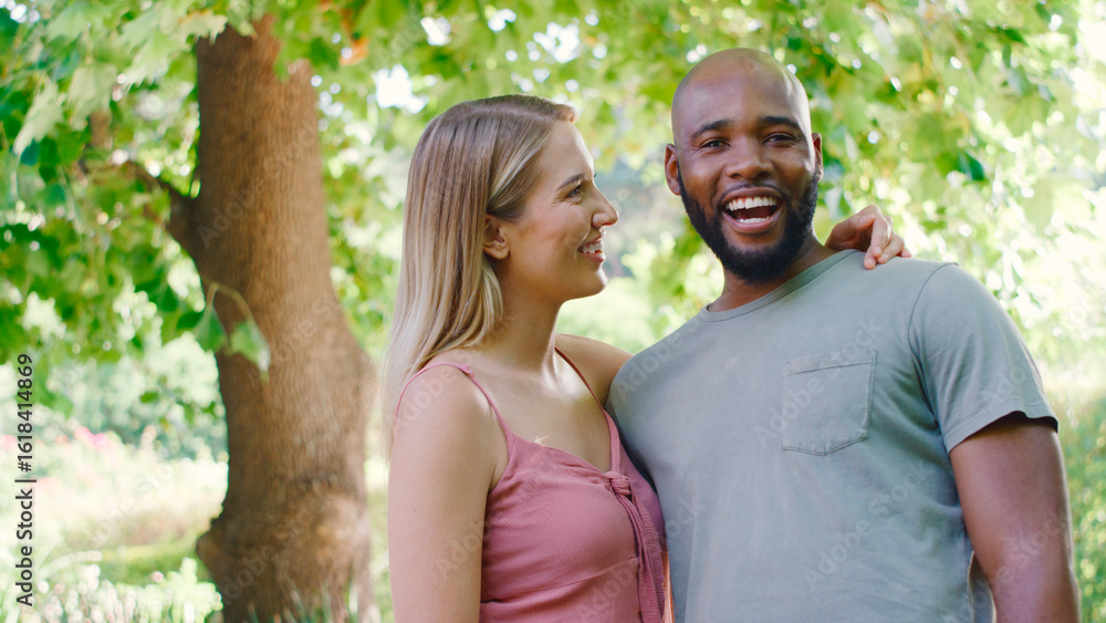Fototapeta premium Portrait Of Loving Multi-Racial Couple Standing Outdoors In Garden Park Or Countryside