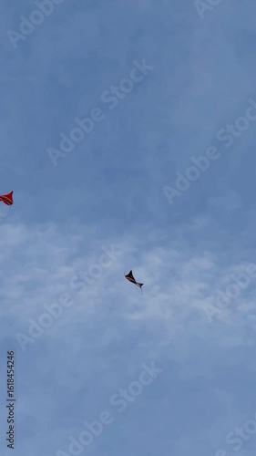 Kite Festival at the Mertasari beach in Sanur,  Bali. A lot of big kites flying on the blue sky