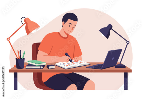 A young man sits at a desk, writing in a notebook while studying with a laptop and books.