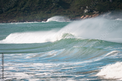 Waves of Praia do Rosa, Brasil. The power of the Atlantic after a huge storm. Big waves hitting the shore