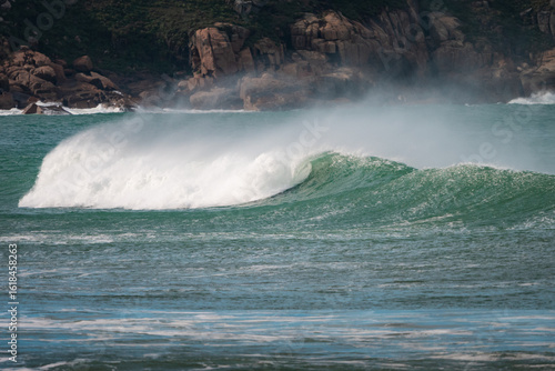 Waves of Praia do Rosa, Brasil. The power of the Atlantic after a huge storm. Big waves hitting the shore