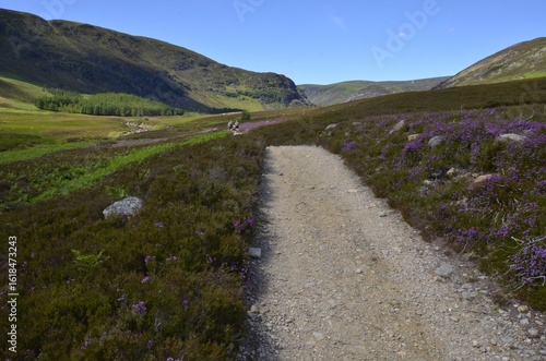 Trekkers walking into Glen Mark in the Cairngorms National Park in Aberdeenshire, Scotland, UK