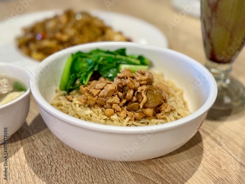 A bowl of bakmi ayam or chicken noodle dish from Indonesia served on the table