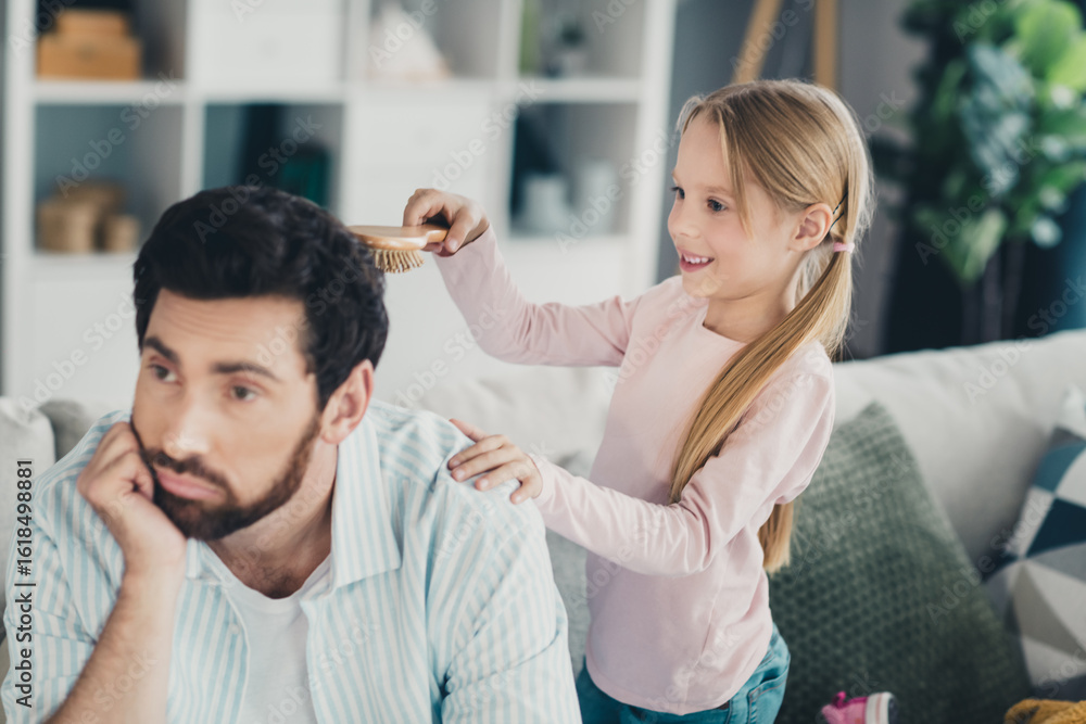 Father and daughter bonding at home as they share a lighthearted moment during a weekend in their cozy apartment Father and daughter bonding at home as they share a lighthearted moment during a weekend in their cozy apartment