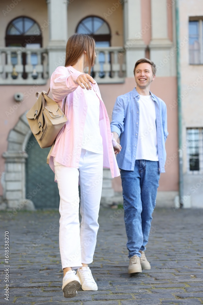 Lovely couple walking together on city street Lovely couple walking together on city street