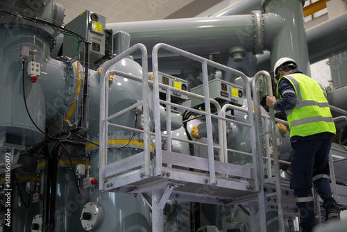 Foto Power station staff working on industrial equipment in factory environment with