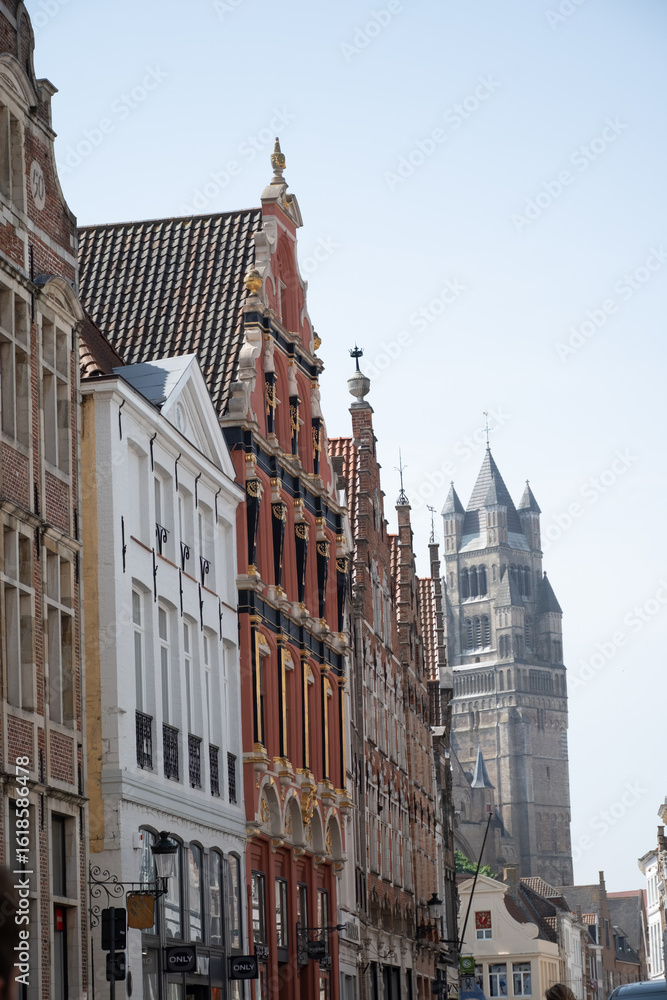 Fototapeta premium Medieval houses facades and rooftops and city tower with bells in the centre of Bruges, Flanders