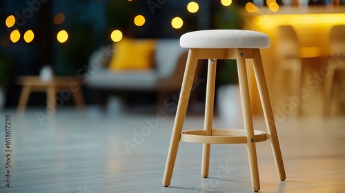A stylish adjustable height bar stool with a light beige cushioned seat sits in a modern home bar setting perfect for relaxing and enjoying drinks with friends.