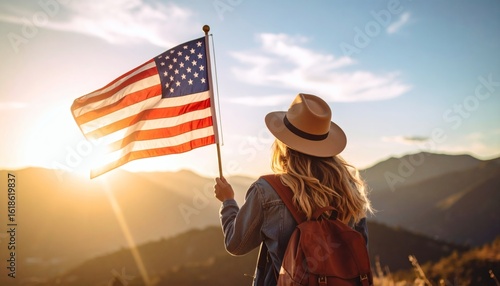Woman with American Flag on Mountain Peak at Sunset