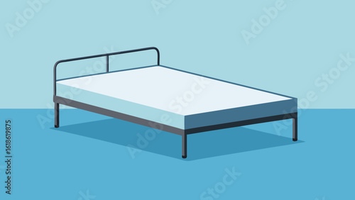 Simple bare mattress on a metal bed frame in a spartan room minimalist