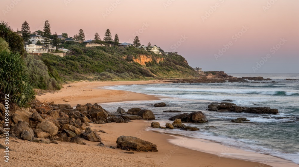 Obraz premium Coastal scene at dawn. Houses on a hilltop overlooking a beach