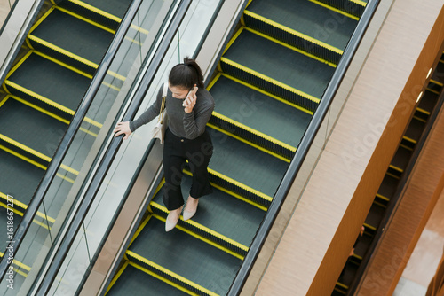 Woman on escalator in shopping mall