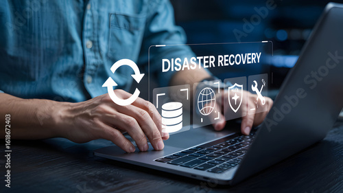 Professional implements modern disaster recovery plan on laptop for secure data backup solutions