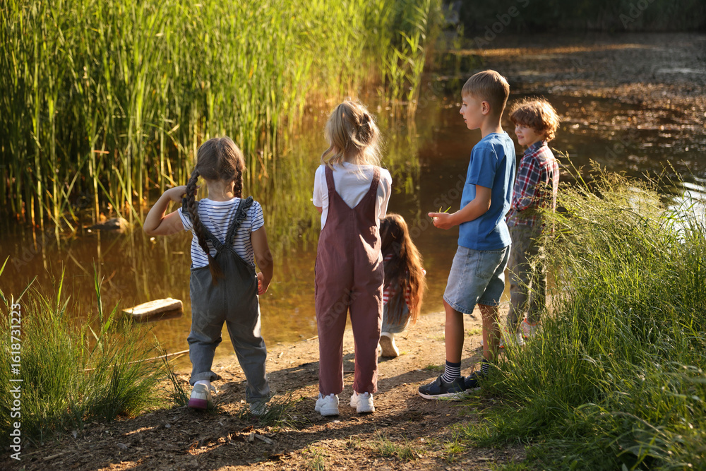 Obraz premium Children spending time by lake in nature