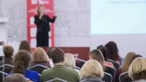 Wallpaper Mural Blurred presenter speaking to seated audience at formal or professional business seminar or workshop Torontodigital.ca