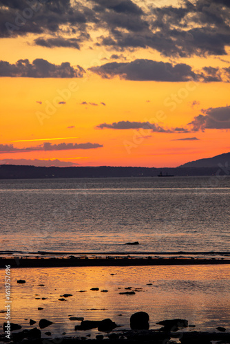 A tranquil horizontal landscape captures the dramatic colors of a sunset over the beach at Port Seton, Scotland