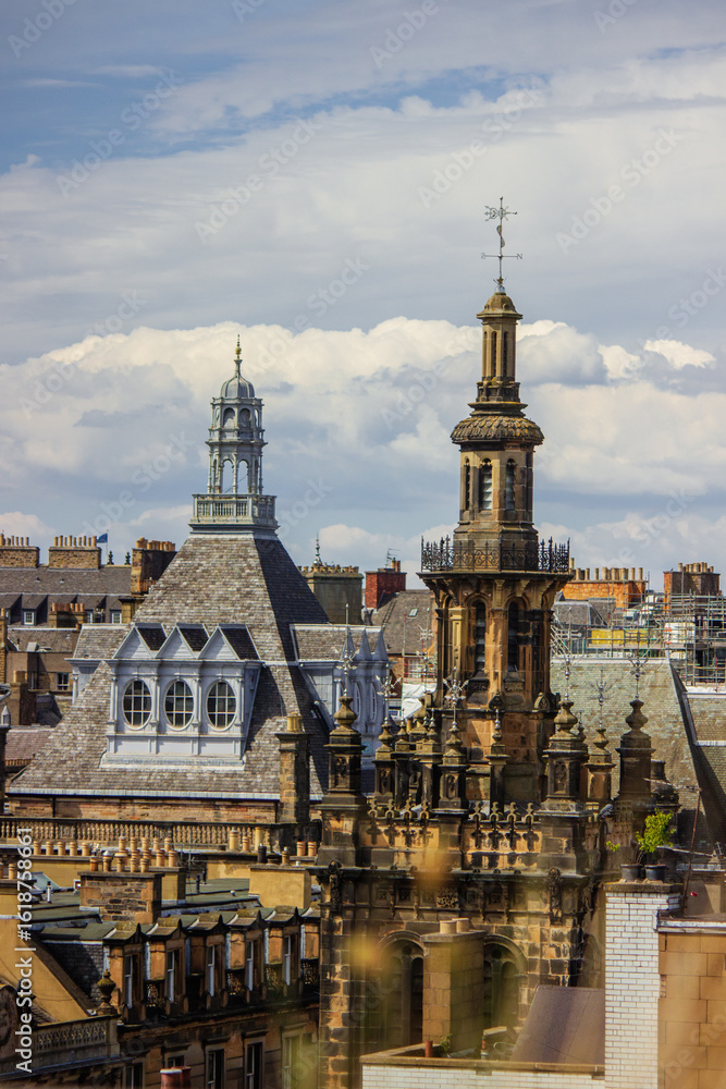 Fototapeta premium A panoramic view captures the historic skyline of Edinburgh, Scotland, under a partly cloudy sky