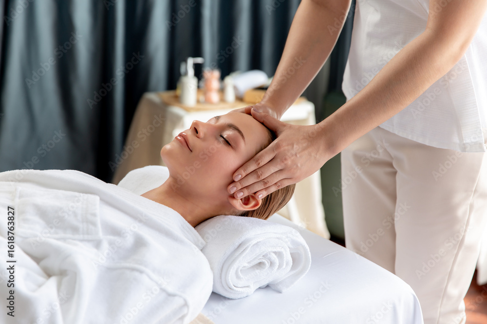 Obraz premium Caucasian woman enjoying relaxing anti-stress head massage and pampering facial beauty skin recreation leisure in dayspa modern light ambient at luxury resort or hotel spa salon. Quiescent