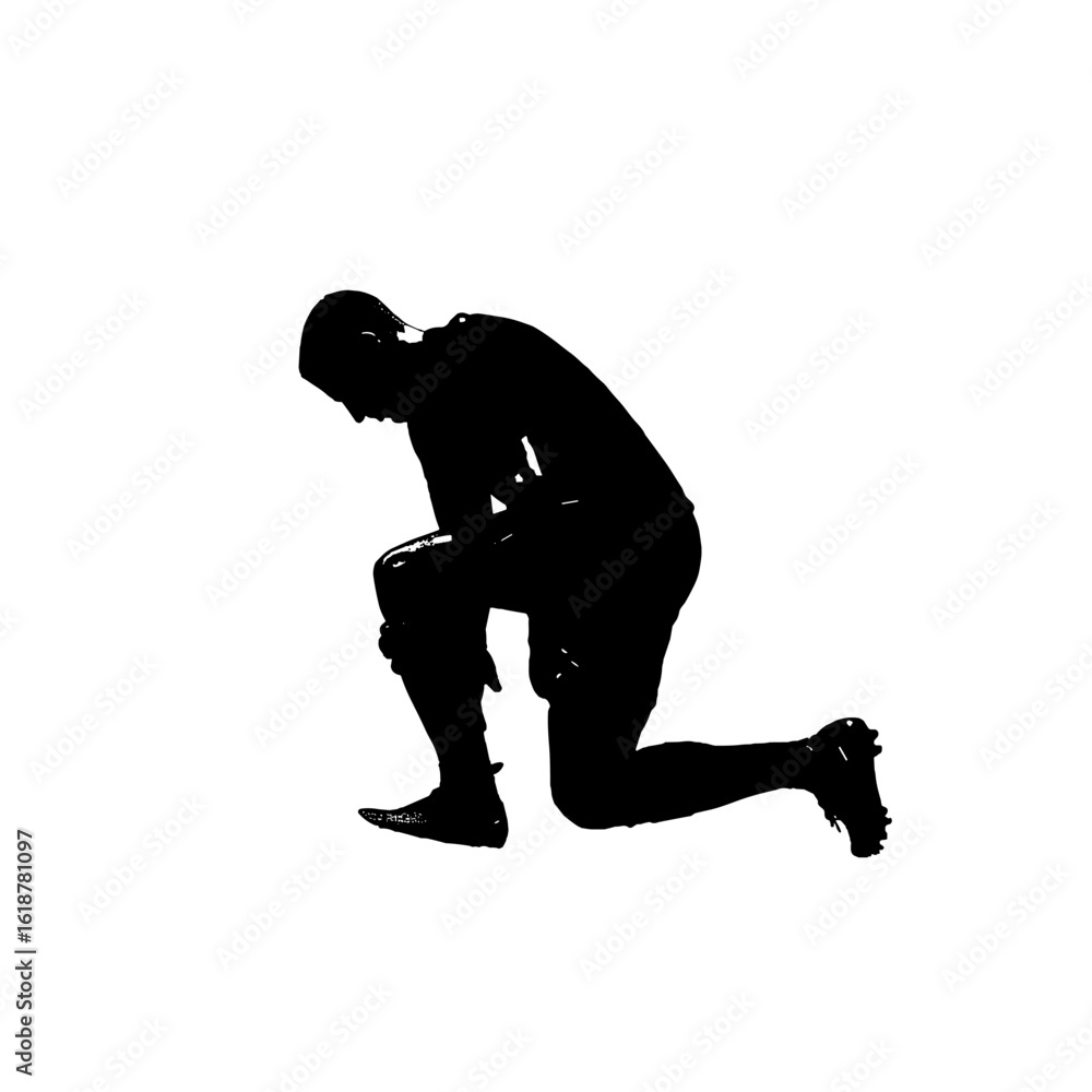 Fototapeta premium Silhouette of a football player kneeling down.