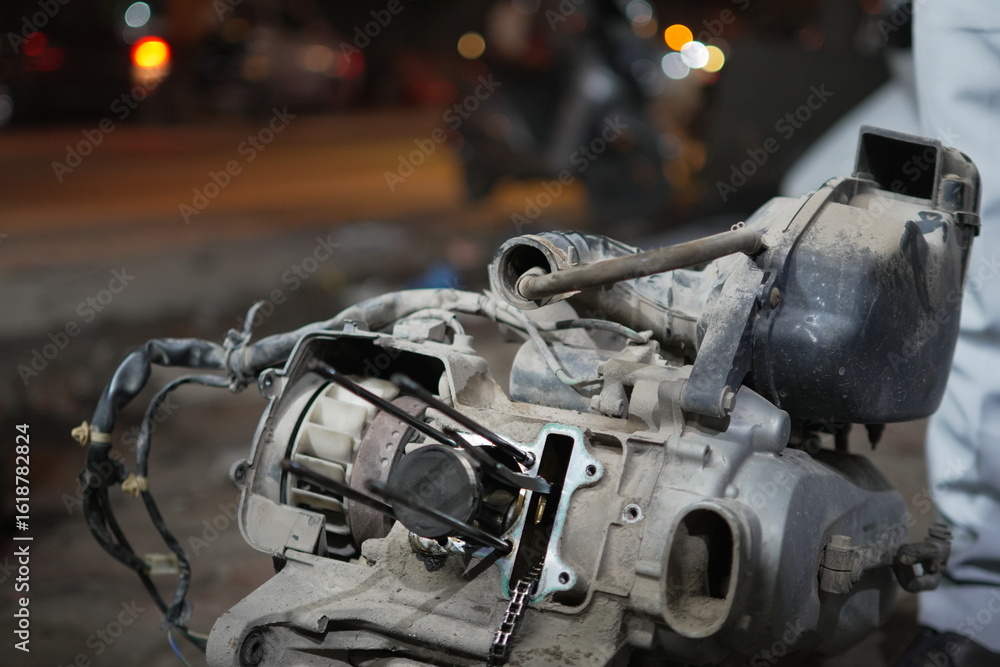 Fototapeta premium Detailed view of an open motorcycle engine undergoing repair and inspection within a mechanical workshop setting, emphasizing intricate components and craftsmanship.