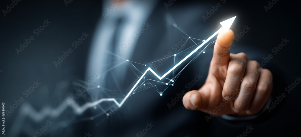Fototapeta premium Businessman touching a glowing upward arrow graph symbolizing business growth, success, and financial progress