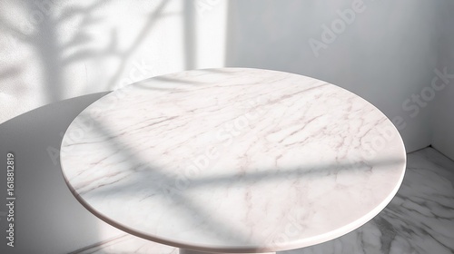 Round marble table top with abstract shadow drop on a white wall background, perfect for mockup product display.