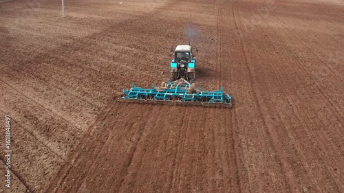 Chasing tractor with a grain seeder& Aerial view