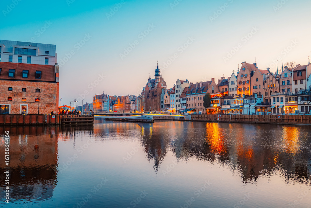 Fototapeta premium Gdansk with Motlawa river in Poland. Old town colourful house with Zuraw or crane and with Holy Spirit Gate