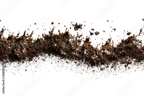 Splash of dark mud wet and clumpy against a stark white backdrop