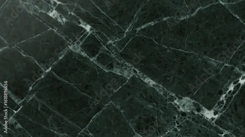 Dark green marble slab with white veins forming a fractured pattern