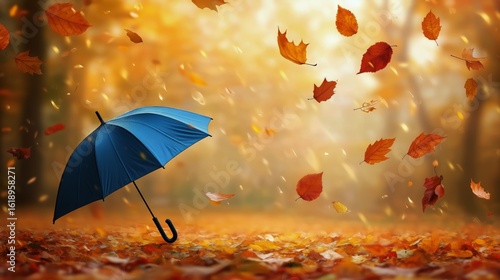 Blue Umbrella in Autumn Leaves With Orange Foliage Swirling in the Breeze Dur...