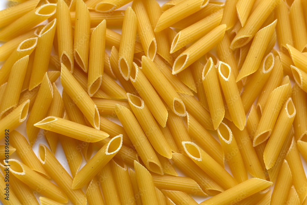 Dry Pasta. Top viewbackground image with dry macaroni noodles. Raw pasta pattern texture. Penne pasta background. Dry Pasta. Top viewbackground image with dry macaroni noodles. Raw pasta pattern texture. Penne pasta background.